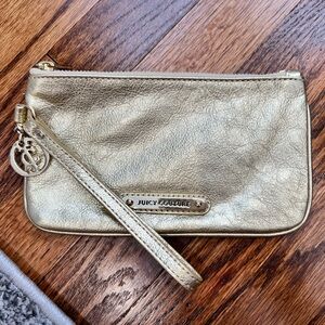 Gold Juicy Couture Wristlet with logo charm and card holders inside wristlet.